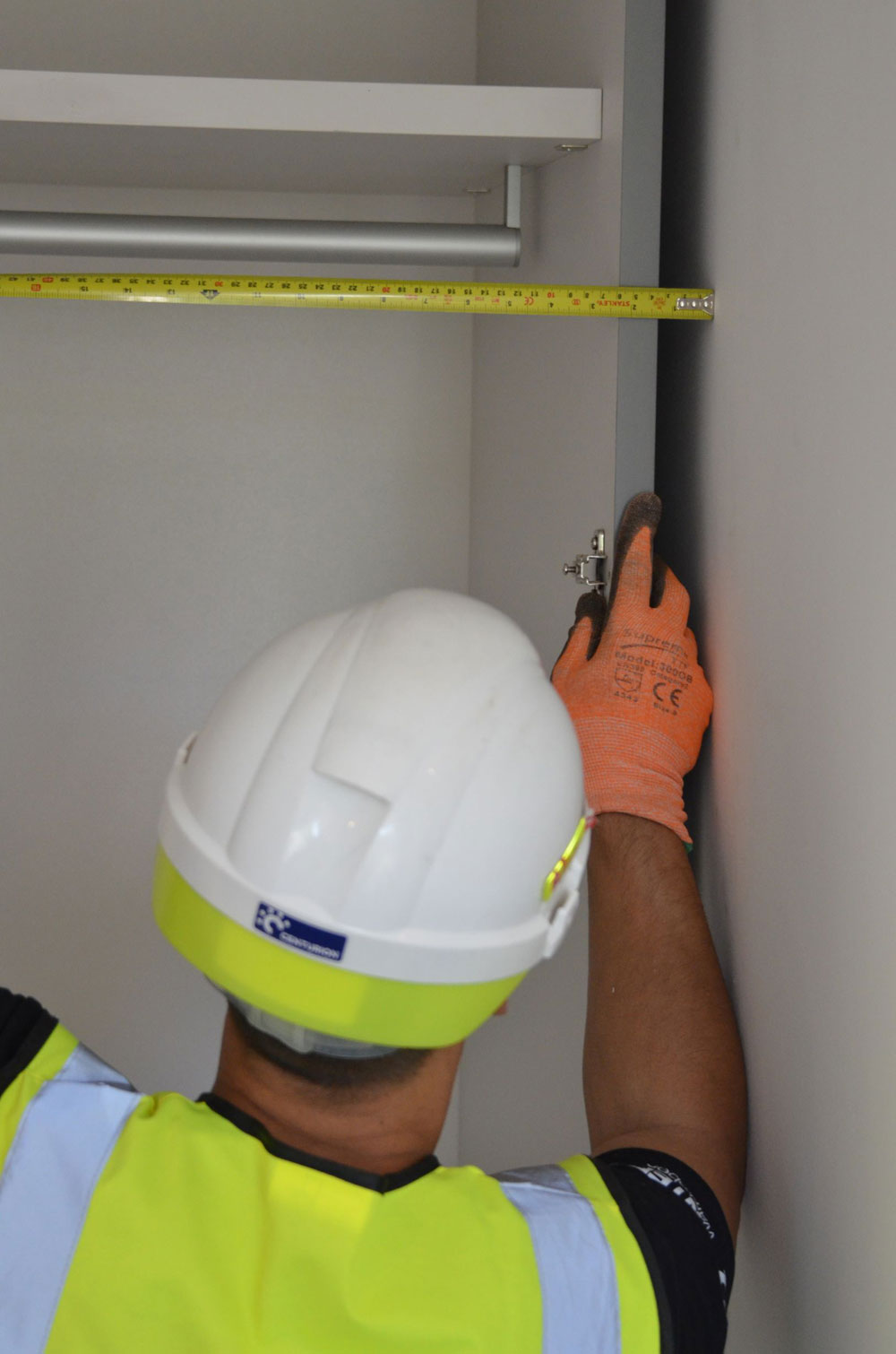 Image of a Pantera Wardrobes installer taking internal measurements